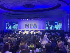 Guests gathered at the MFA Miami event while financial experts speak.